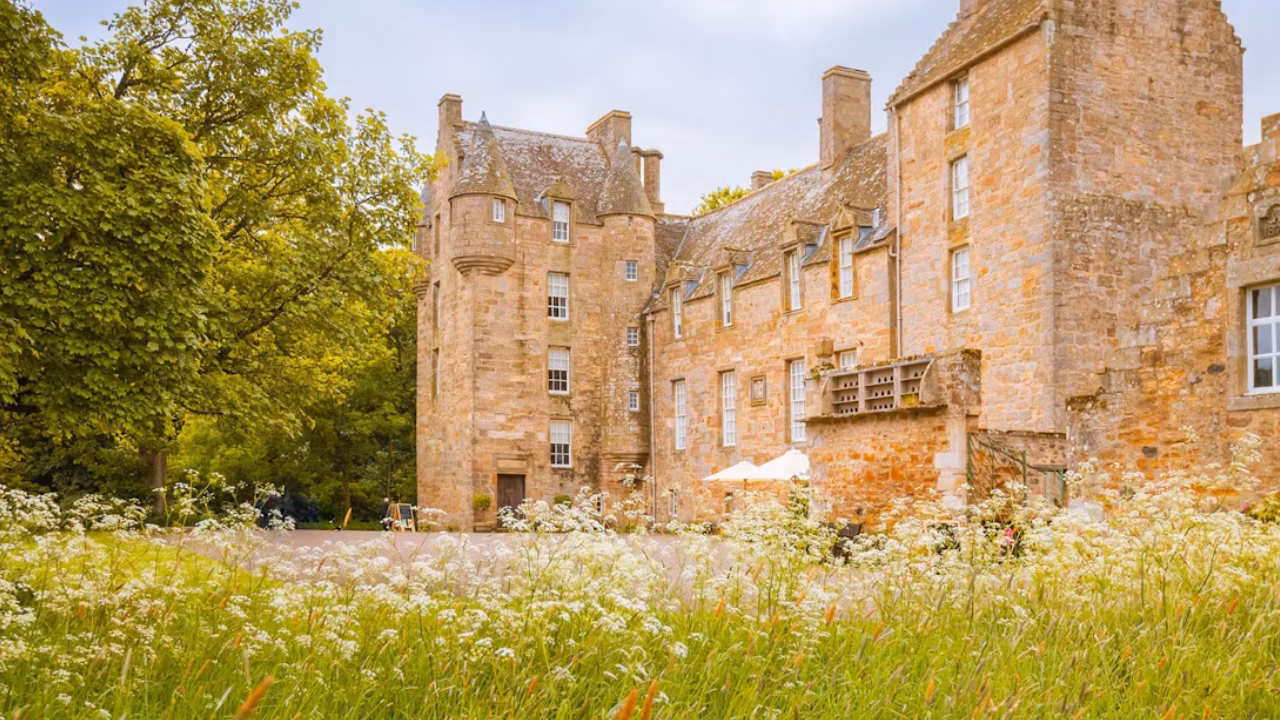 Kellie Castle surrounded by trees and flowering gardens in the East Neuk of Fife.