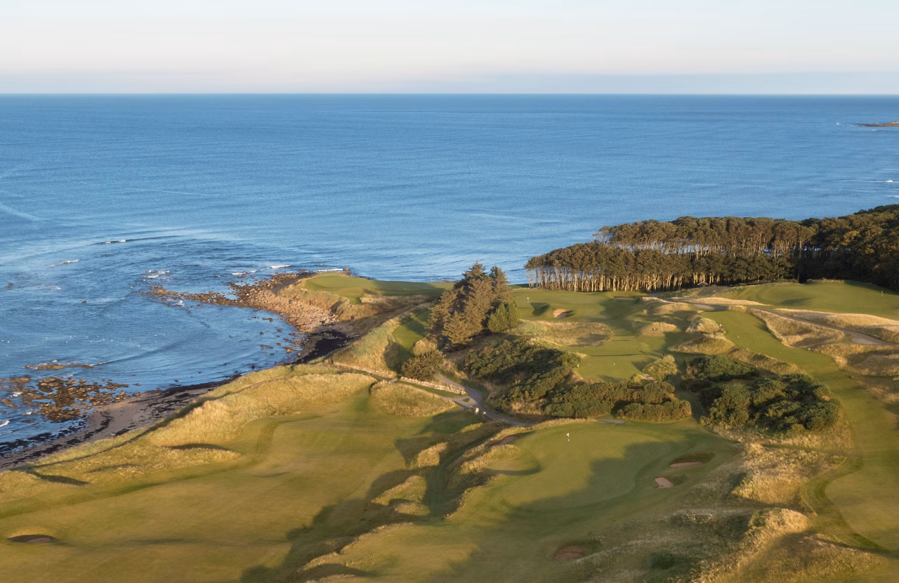 Aerial view of Kingsbarns Golf Links beside the North Sea coastline.