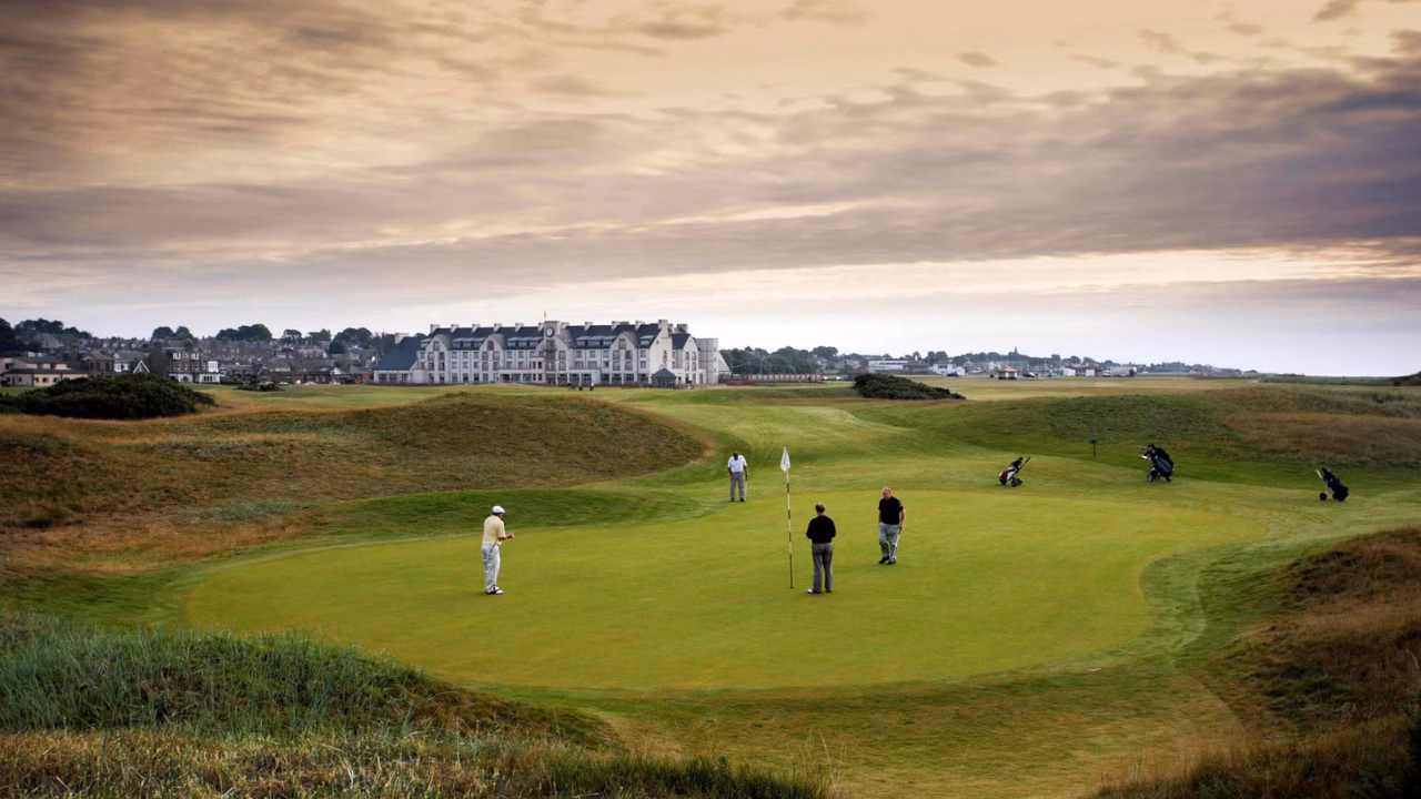 Carnoustie Golf Links' Championship Course with golfers on a green.