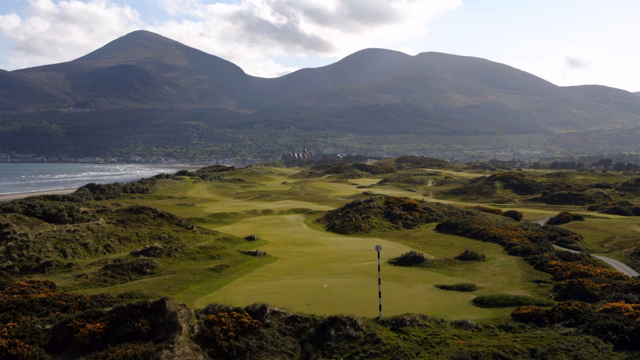 Royal County Down Golf Club's Championship Links with dunes and the Mourne Mountains behind.