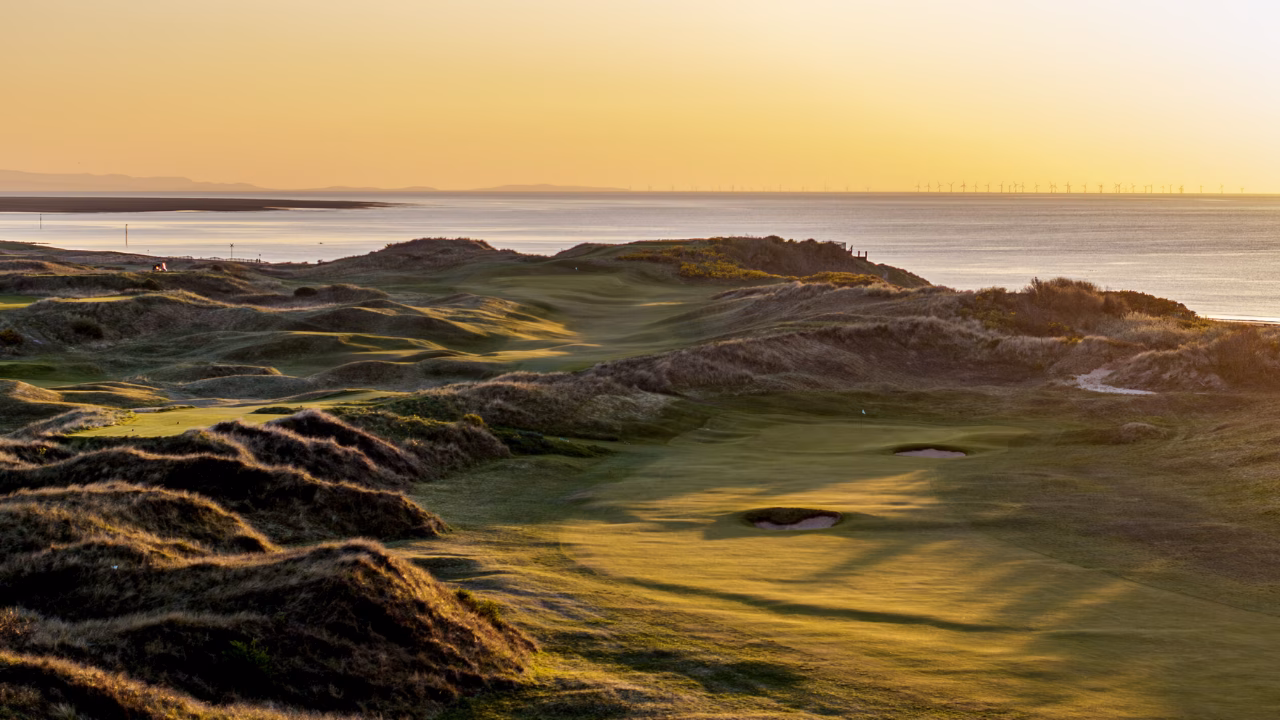 Wallasey Golf Club links course overlooking the coast at sunset.