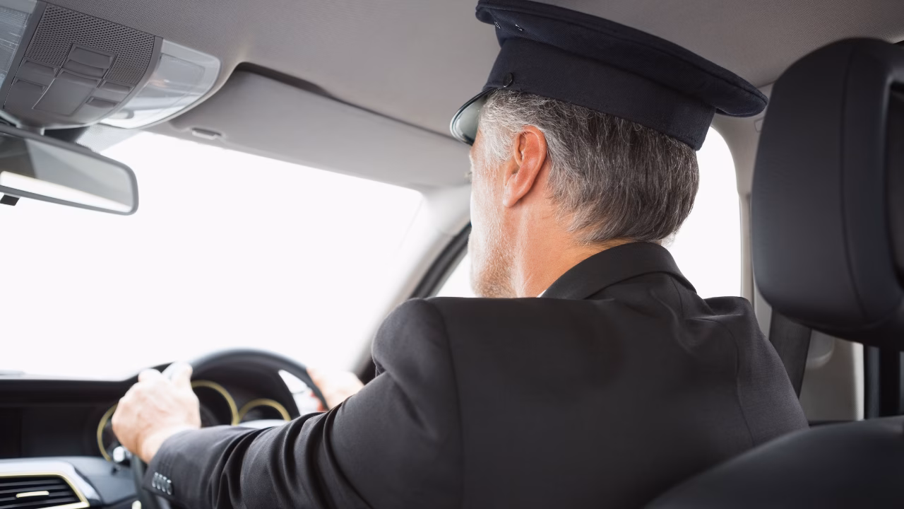 Professional chauffeur driving a private vehicle.