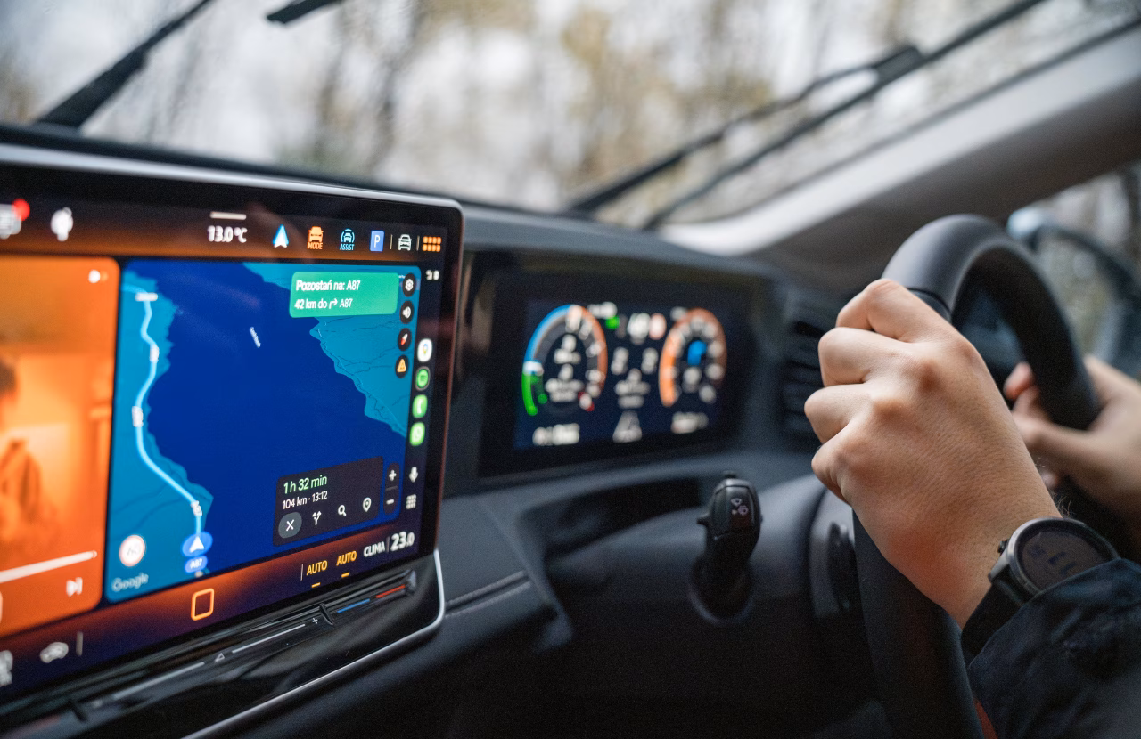 Driver using in-car navigation while travelling by road.