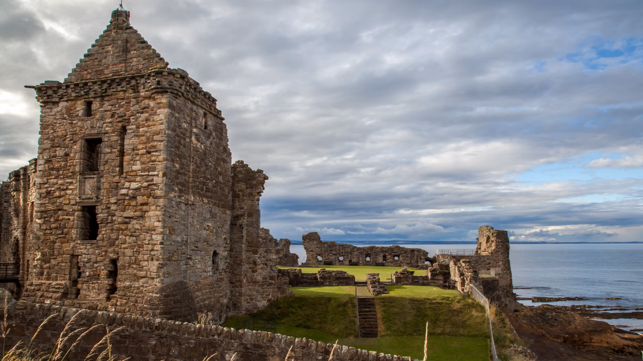 Ruins of St Andrews Castle standing above the rocky coastline and North Sea.