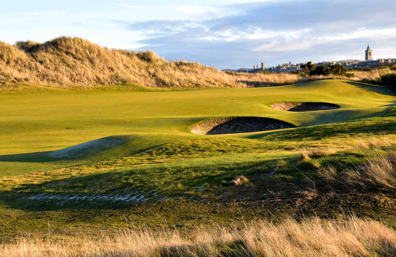 The Jubilee Course with bunkers, links dunes, and St Andrews in the distance.