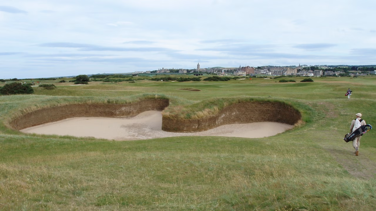 Hell Bunker on the Old Course's 14th hole with St Andrews visible in the distance.