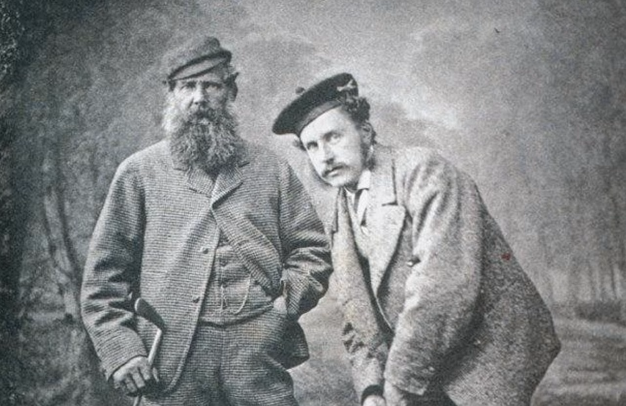 Old Tom Morris standing beside his son, Young Tom Morris.