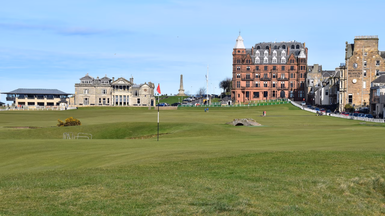 Old Course 18th fairway and Swilcan Bridge with the R&A Clubhouse and St Andrews beyond.