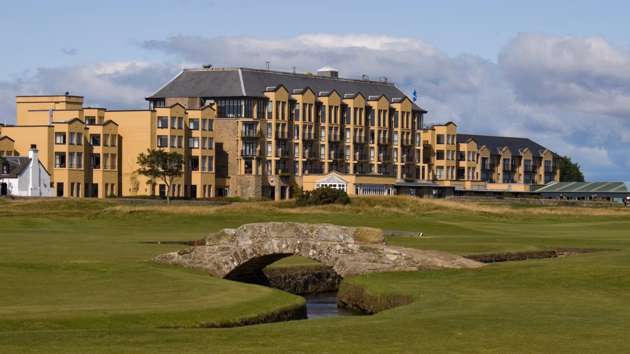 Swilcan Bridge crossing the burn on the Old Course with the Old Course Hotel in the background.